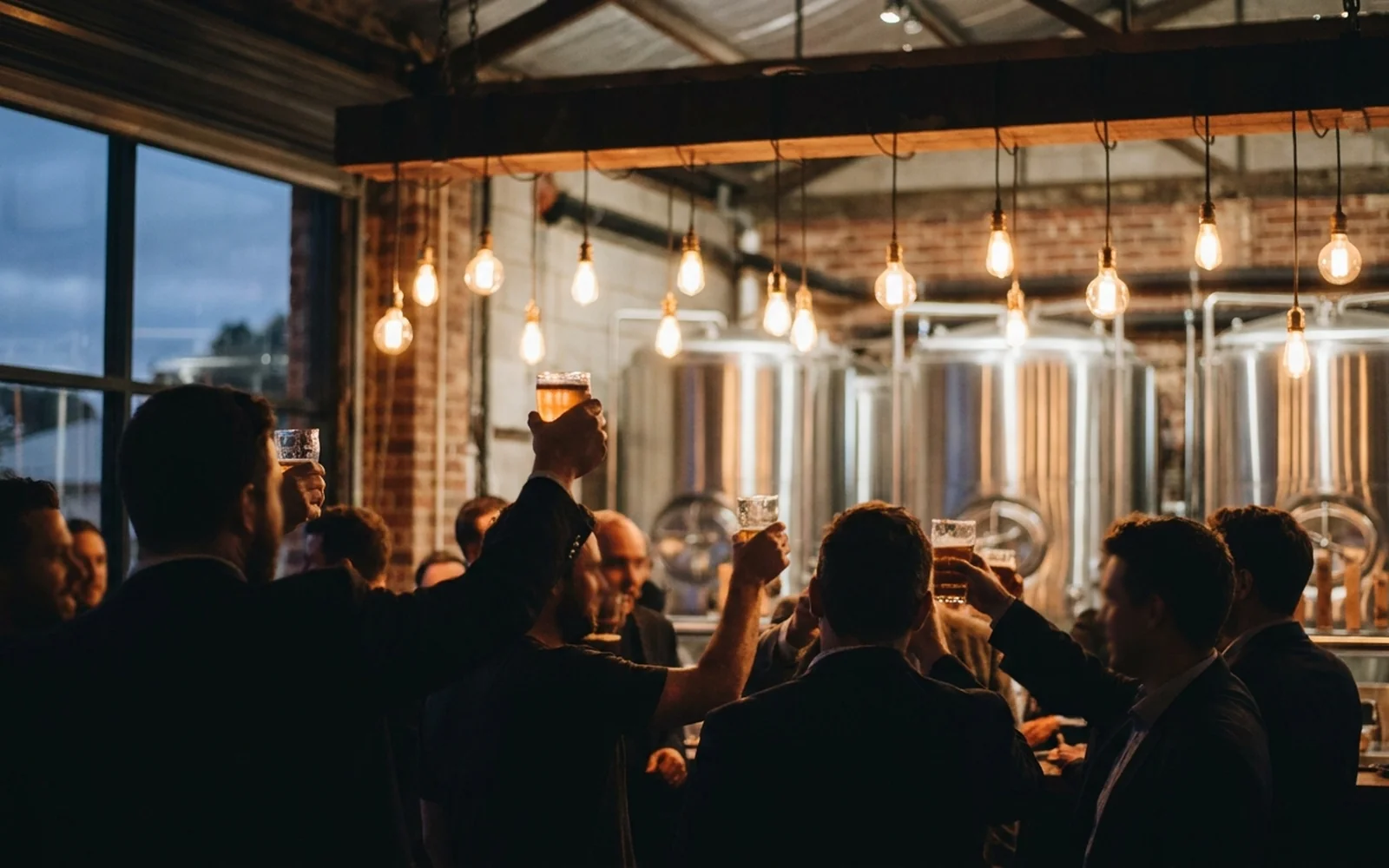 A bucks group raising pints at an Adelaide brewery at dusk