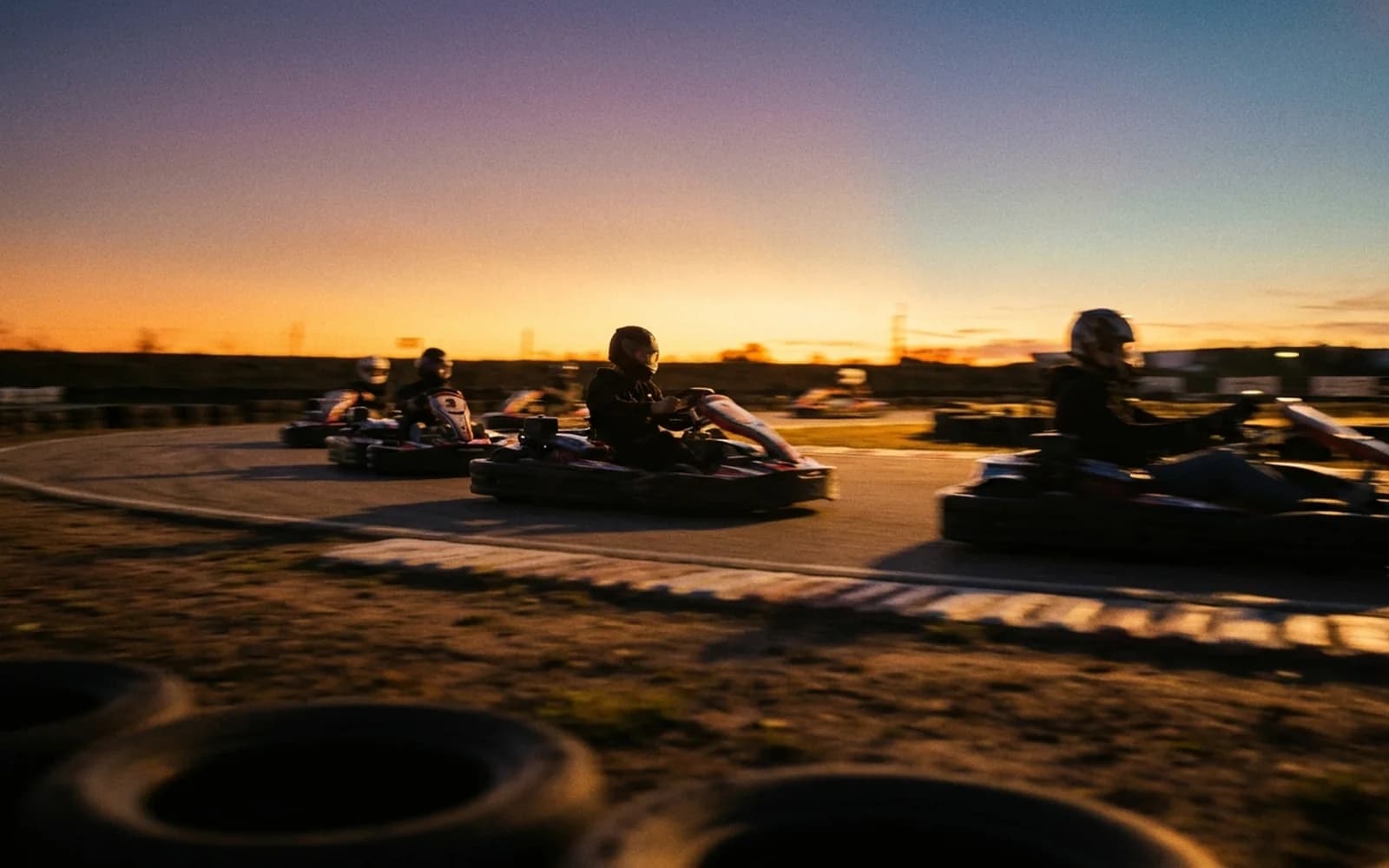 A bucks group go-karting in silhouette at golden hour